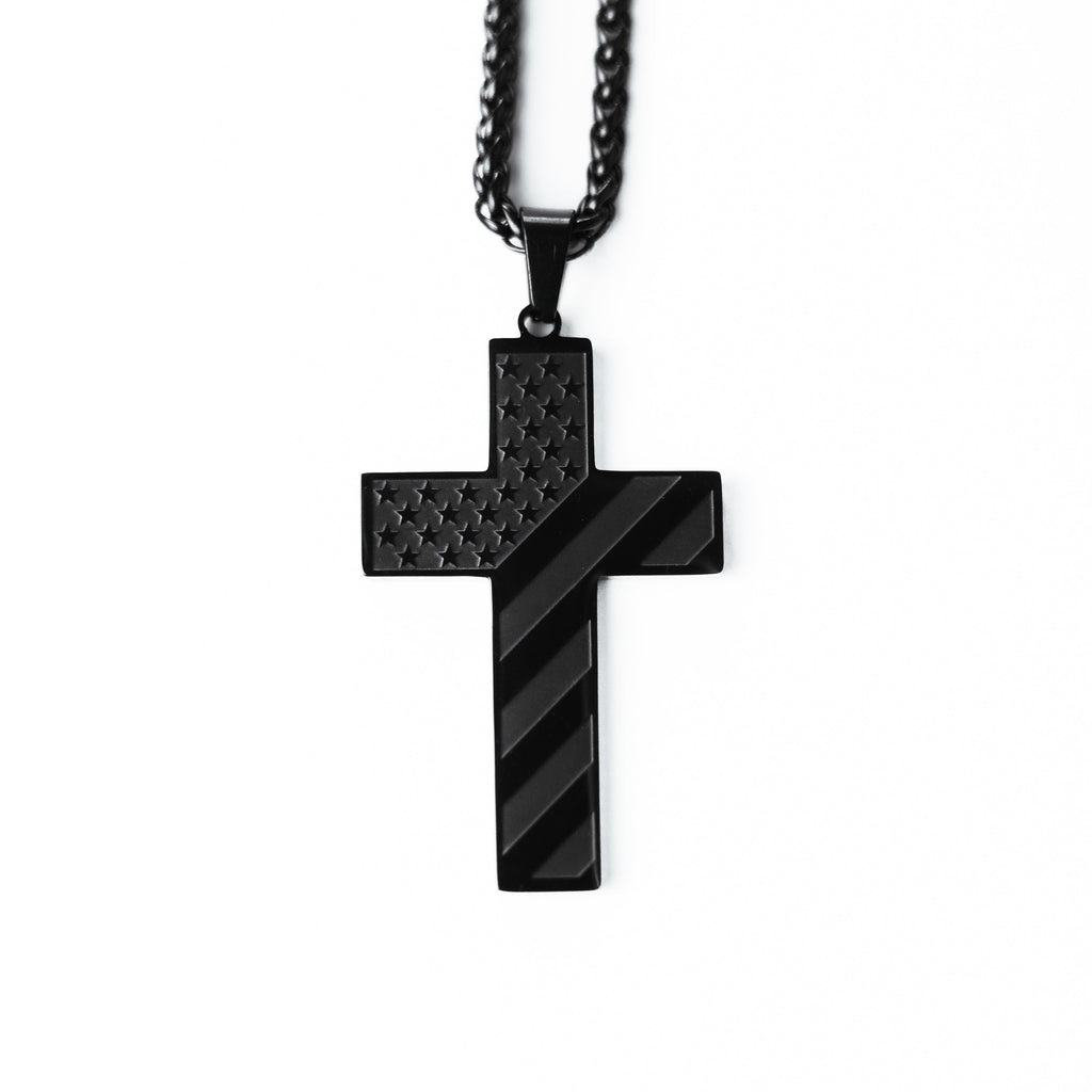 Black cross pendant necklace on a white background