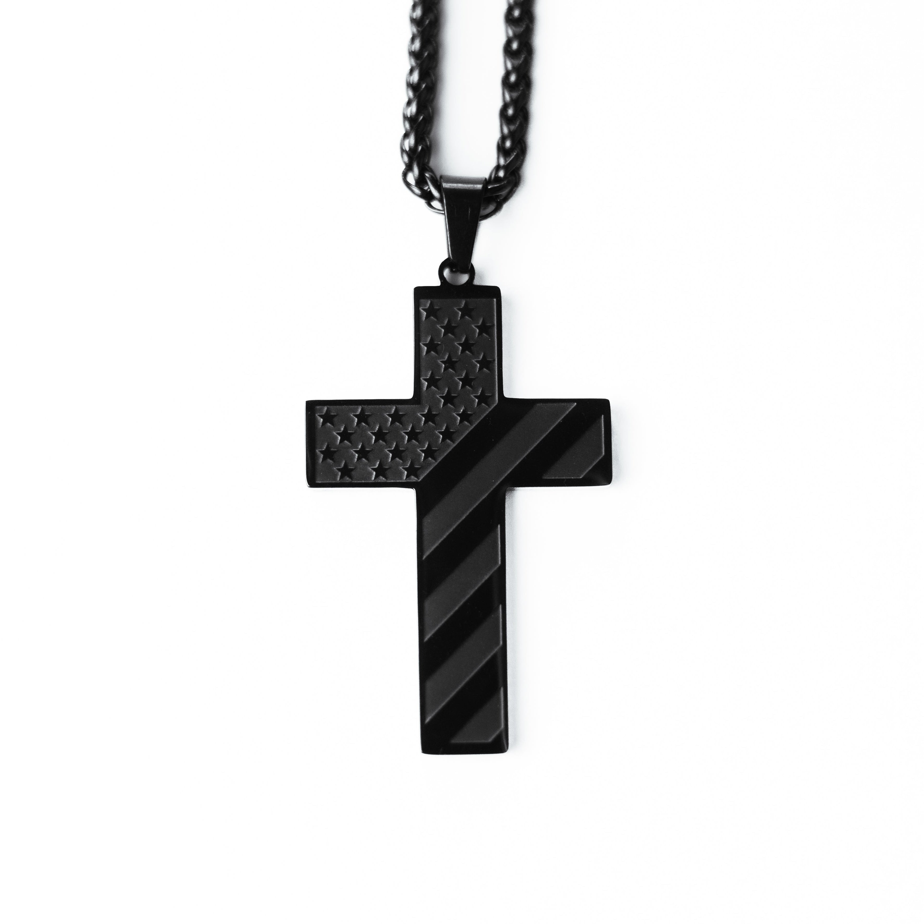 Black cross pendant necklace on a white background